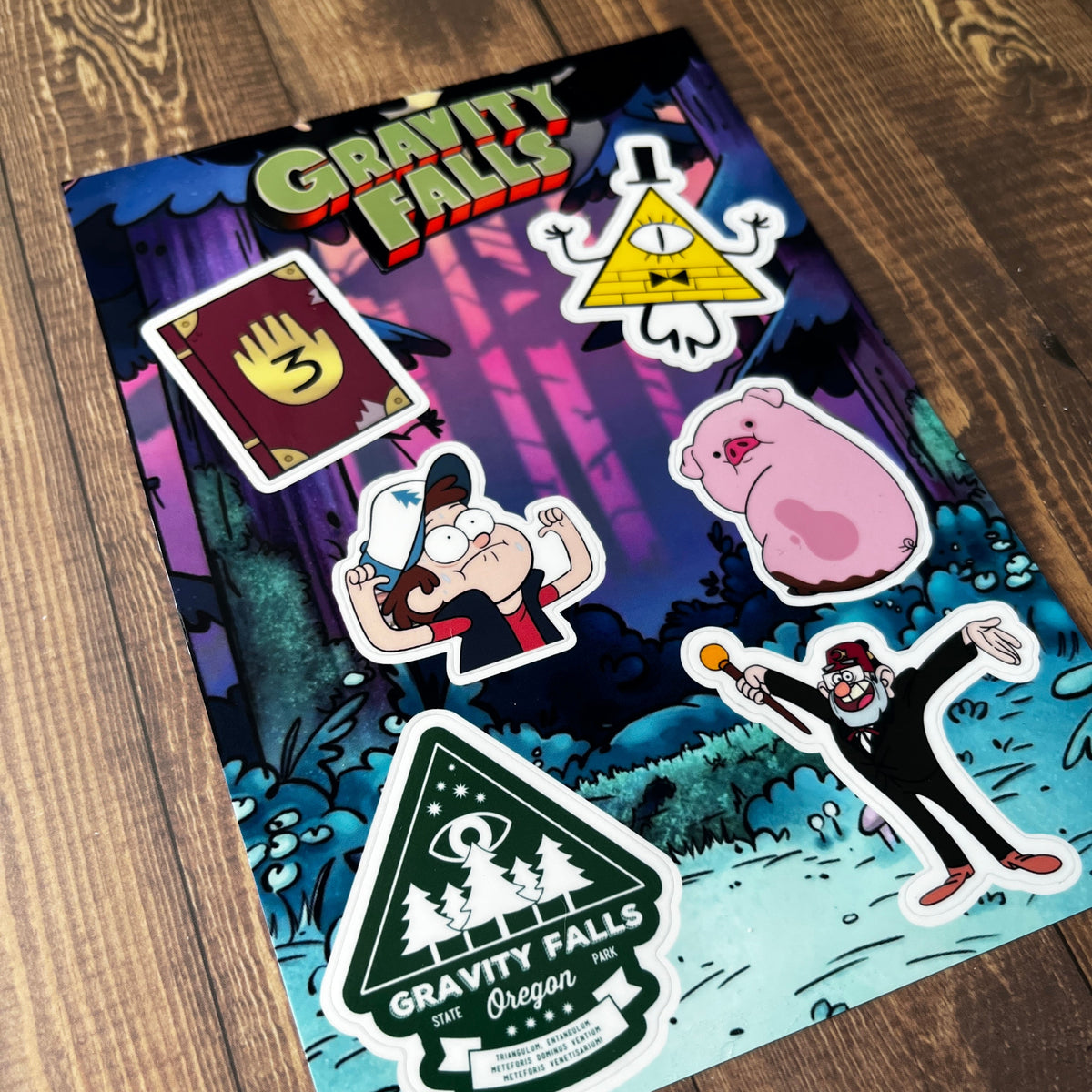 Stickers on a colorful notebook on a wooden surface