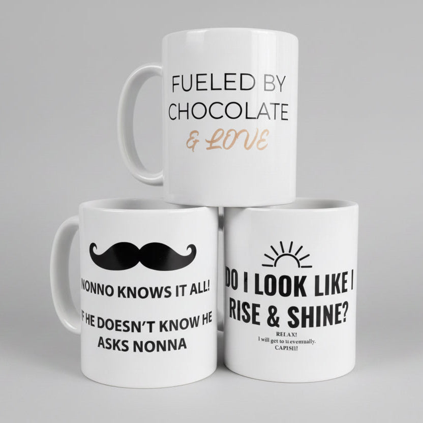 Three white mugs with humorous text designs on a gray background