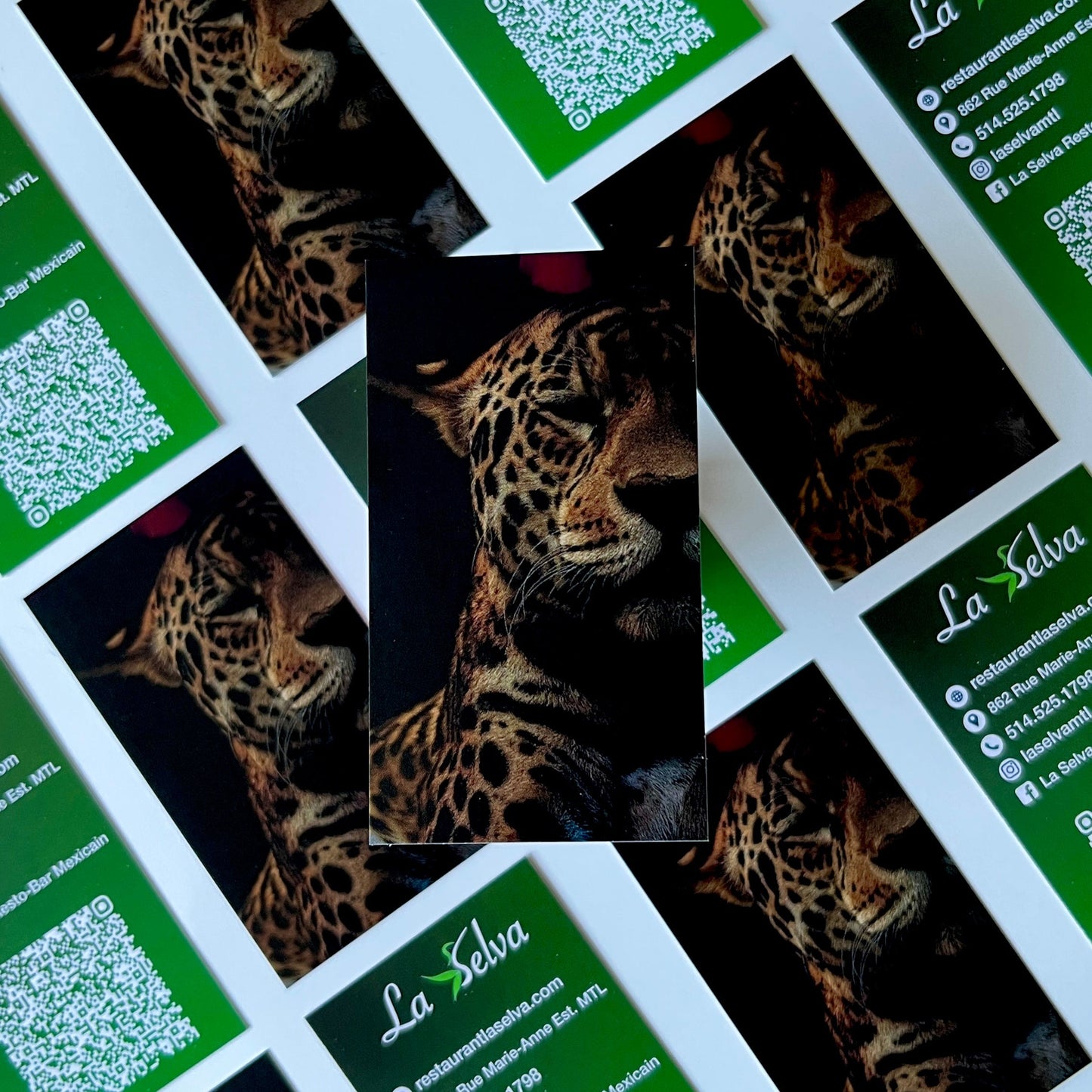 Business cards with leopard pattern and QR code on a grid layout