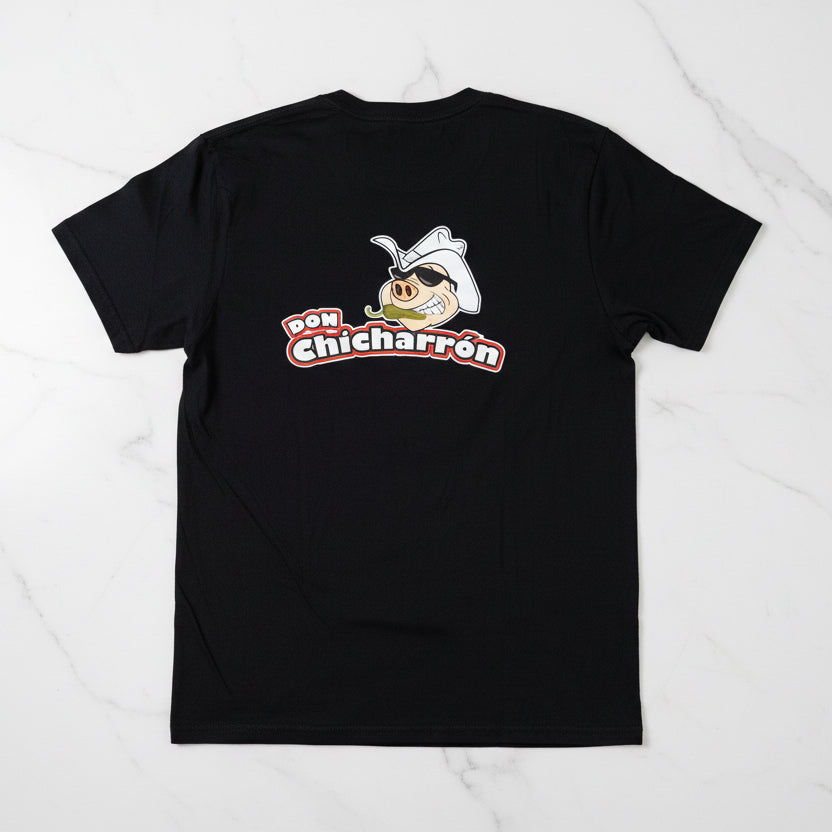 Black t-shirt with 'Don Chicharrón' logo on a wooden surface