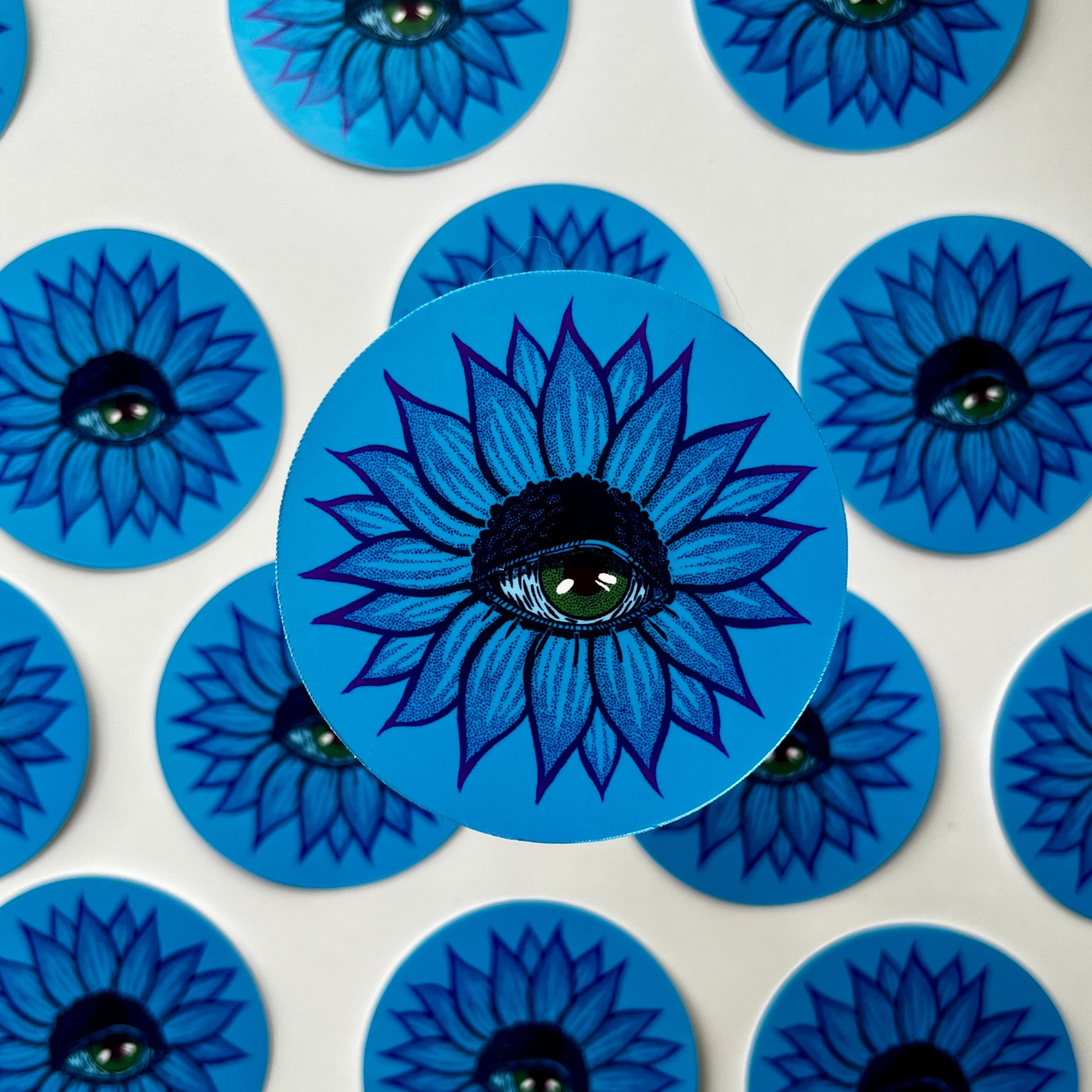 Blue circular stickers with floral design on a white background
