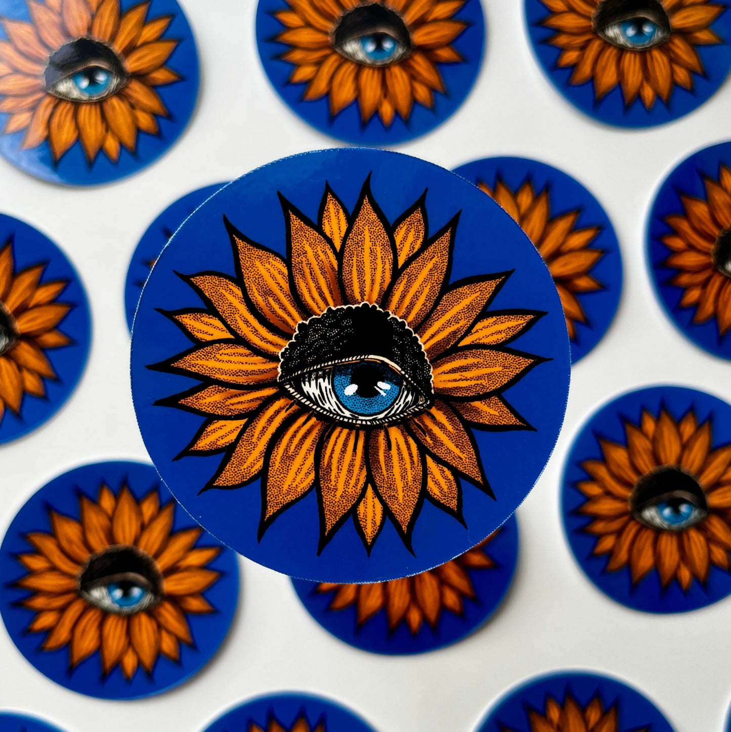 Stickers with sunflower design and eye on blue background
