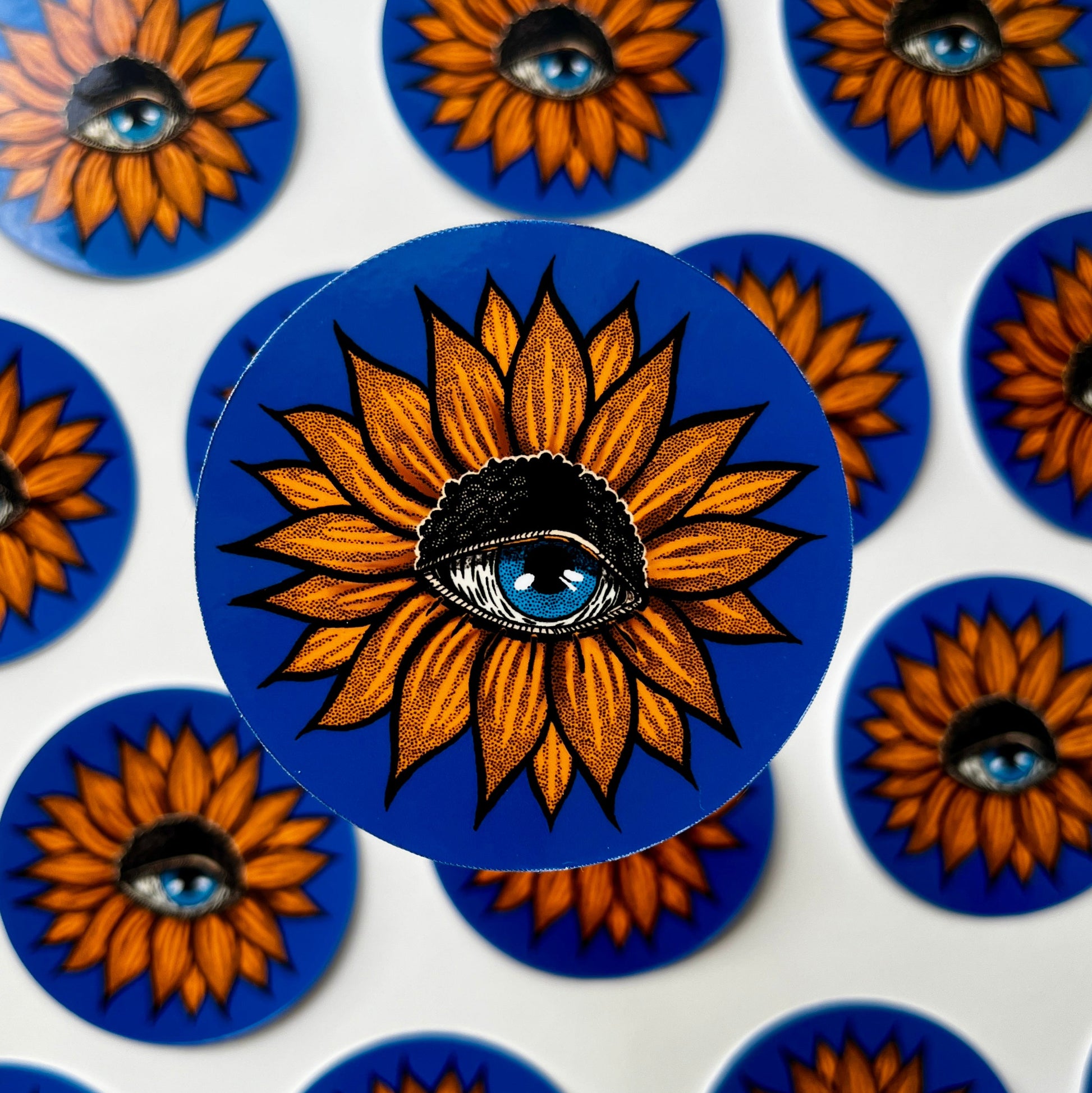 Stickers with sunflower design and eye on blue background