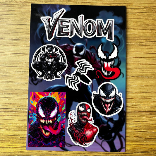 Collection of Venom-themed stickers on a wooden surface