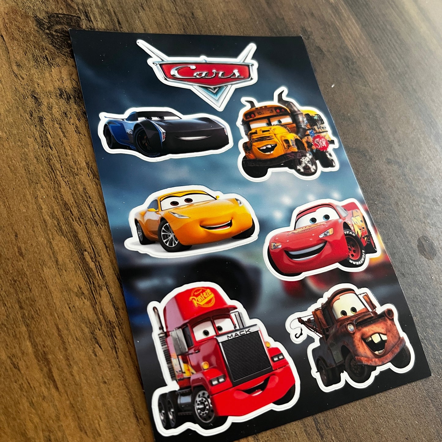 Set of 'Cars' themed stickers on a dark surface